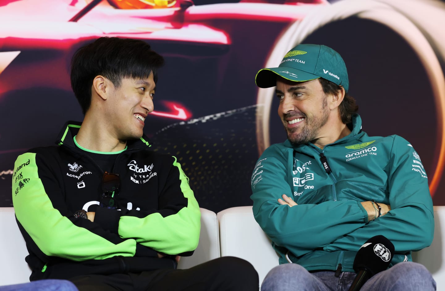 SHANGHAI, CHINA - APRIL 18: Zhou Guanyu of China and Stake F1 Team Kick Sauber and Fernando Alonso of Spain and Aston Martin F1 Team talk in the Drivers Press Conference during previews ahead of the F1 Grand Prix of China at Shanghai International Circuit on April 18, 2024 in Shanghai, China. (Photo by Lintao Zhang/Getty Images )