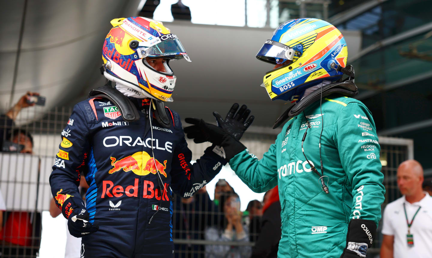 SHANGHAI, CHINA - APRIL 20: Second placed qualifier Sergio Perez of Mexico and Oracle Red Bull Racing and Third placed qualifier Fernando Alonso of Spain and Aston Martin F1 Team celebrate in parc ferme after qualifying ahead of the F1 Grand Prix of China at Shanghai International Circuit on April 20, 2024 in Shanghai, China. (Photo by Bryn Lennon - Formula 1/Formula 1 via Getty Images)