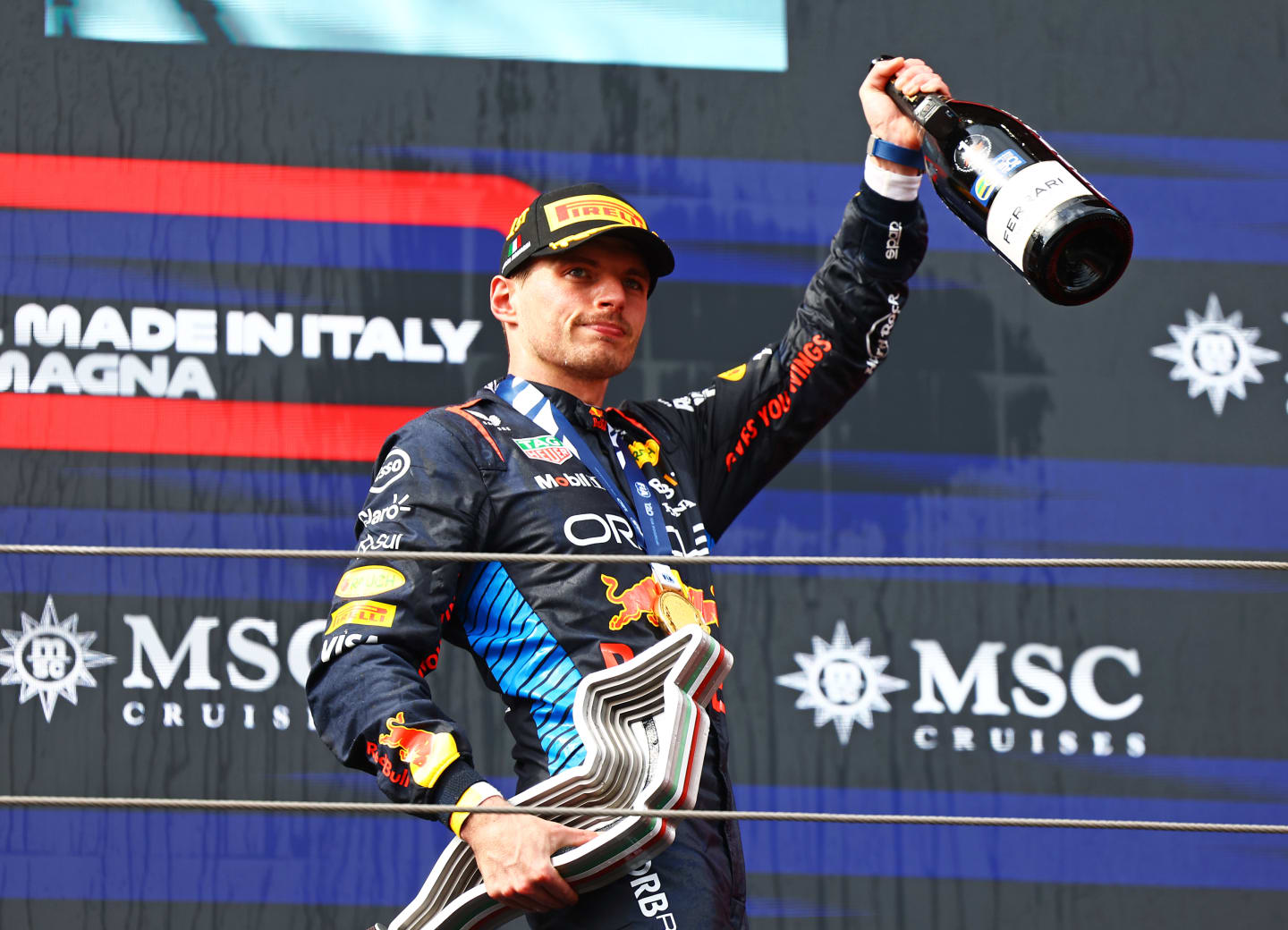 IMOLA, ITALY - MAY 19: Race winner Max Verstappen of the Netherlands and Oracle Red Bull Racing celebrates on the podium during the F1 Grand Prix of Emilia-Romagna at Autodromo Enzo e Dino Ferrari Circuit on May 19, 2024 in Imola, Italy. (Photo by Mark Thompson/Getty Images)