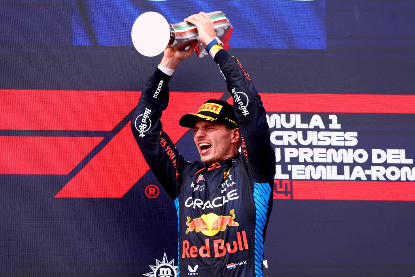 IMOLA, ITALY - MAY 19: Race winner Max Verstappen of the Netherlands and Oracle Red Bull Racing celebrates on the podium during the F1 Grand Prix of Emilia-Romagna at Autodromo Enzo e Dino Ferrari Circuit on May 19, 2024 in Imola, Italy. (Photo by Clive Rose/Getty Images)