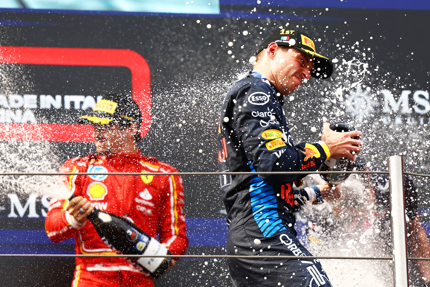IMOLA, ITALY - MAY 19: Race winner Max Verstappen of the Netherlands and Oracle Red Bull Racing celebrates on the podium during the F1 Grand Prix of Emilia-Romagna at Autodromo Enzo e Dino Ferrari Circuit on May 19, 2024 in Imola, Italy. (Photo by Mark Thompson/Getty Images)