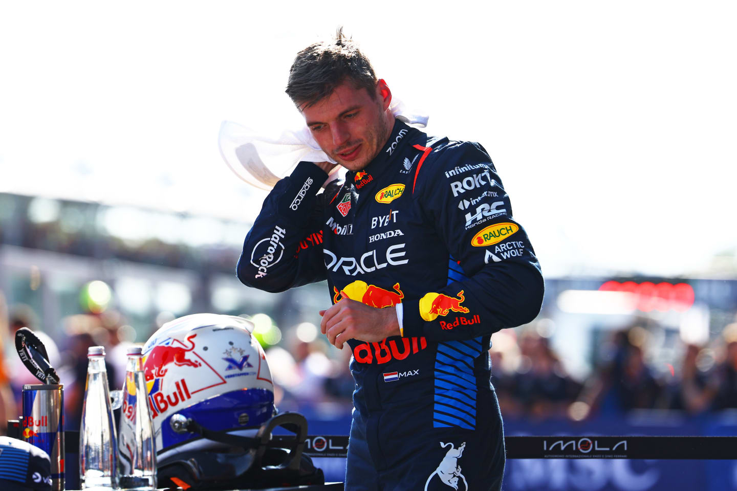 IMOLA, ITALY - MAY 18: Pole position qualifier Max Verstappen of the Netherlands and Oracle Red Bull Racing wipes his head with a towel in parc ferme during qualifying ahead of the F1 Grand Prix of Emilia-Romagna at Autodromo Enzo e Dino Ferrari Circuit on May 18, 2024 in Imola, Italy. (Photo by Mark Thompson/Getty Images)