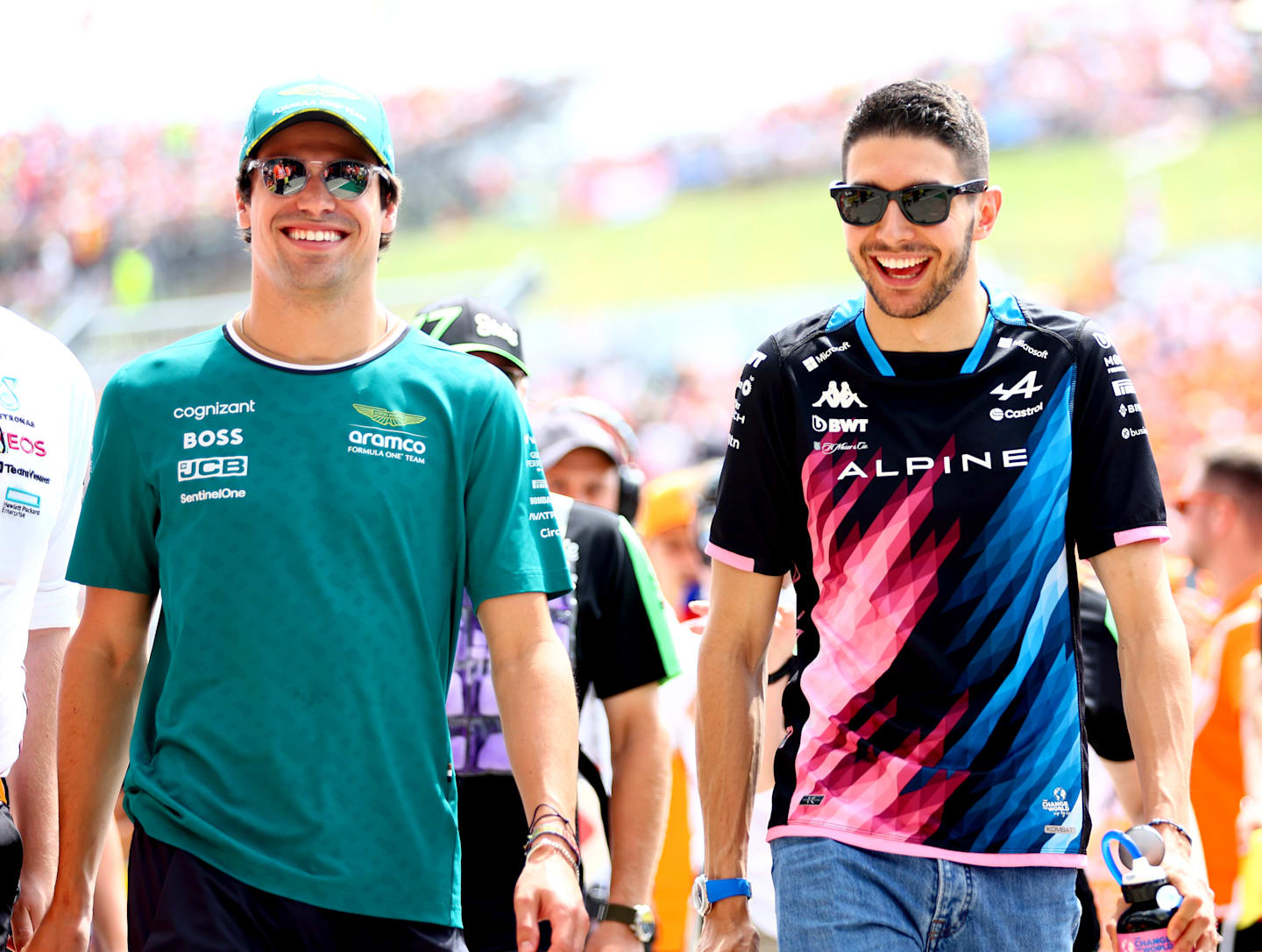 BUDAPEST, HUNGARY - JULY 21: Lance Stroll of Canada and Aston Martin F1 Team and Esteban Ocon of France and Alpine F1 talk on the drivers parade prior to the F1 Grand Prix of Hungary at Hungaroring on July 21, 2024 in Budapest, Hungary. (Photo by Bryn Lennon - Formula 1/Formula 1 via Getty Images)