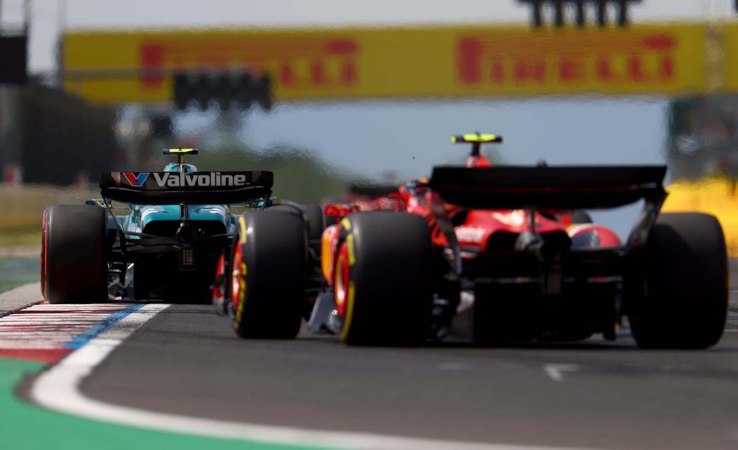 BUDAPEST, HUNGARY - JULY 21: Fernando Alonso of Spain driving the (14) Aston Martin AMR24 Mercedes leads Carlos Sainz of Spain driving (55) the Ferrari SF-24 on track during the F1 Grand Prix of Hungary at Hungaroring on July 21, 2024 in Budapest, Hungary. (Photo by Bryn Lennon - Formula 1/Formula 1 via Getty Images)