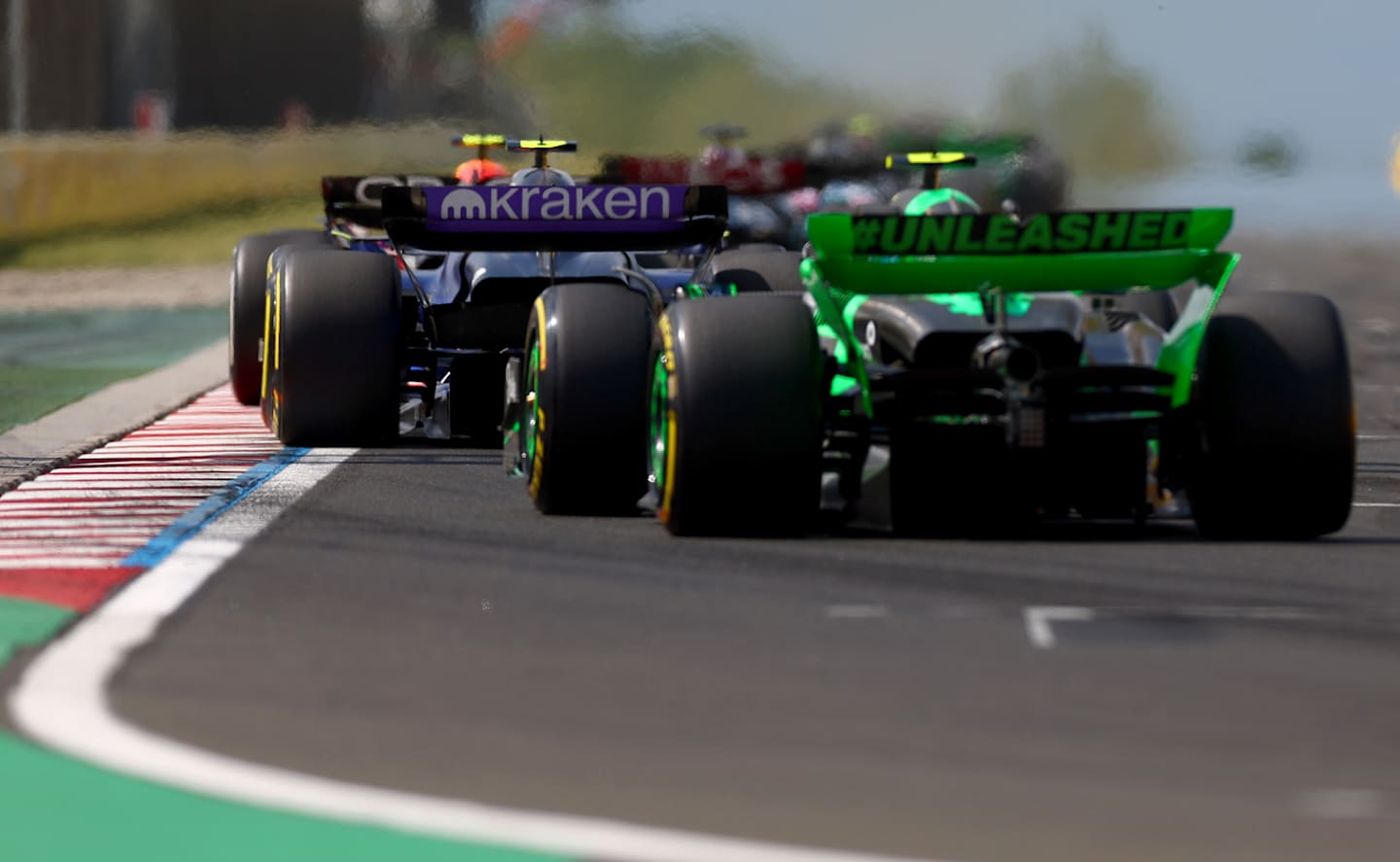 BUDAPEST, HUNGARY - JULY 21: Logan Sargeant of United States driving the (2) Williams FW46 Mercedes leads Zhou Guanyu of China driving the (24) Kick Sauber C44 Ferrari during the F1 Grand Prix of Hungary at Hungaroring on July 21, 2024 in Budapest, Hungary. (Photo by Bryn Lennon - Formula 1/Formula 1 via Getty Images)