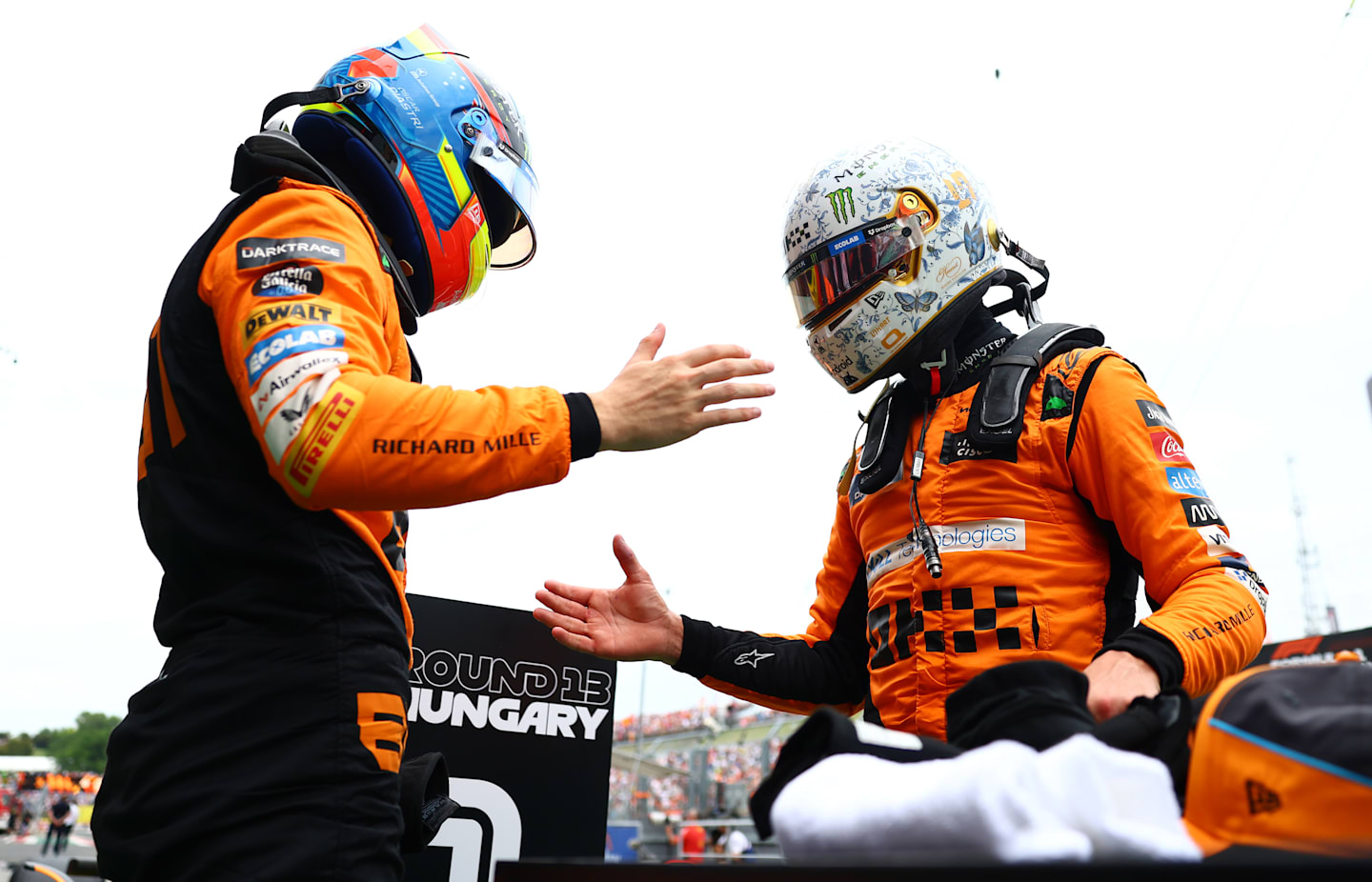 BUDAPEST, HUNGARY - JULY 20: Pole position qualifier Lando Norris of Great Britain and McLaren and Second placed qualifier Oscar Piastri of Australia and McLaren celebrate in parc ferme during qualifying ahead of the F1 Grand Prix of Hungary at Hungaroring on July 20, 2024 in Budapest, Hungary. (Photo by Bryn Lennon - Formula 1/Formula 1 via Getty Images)