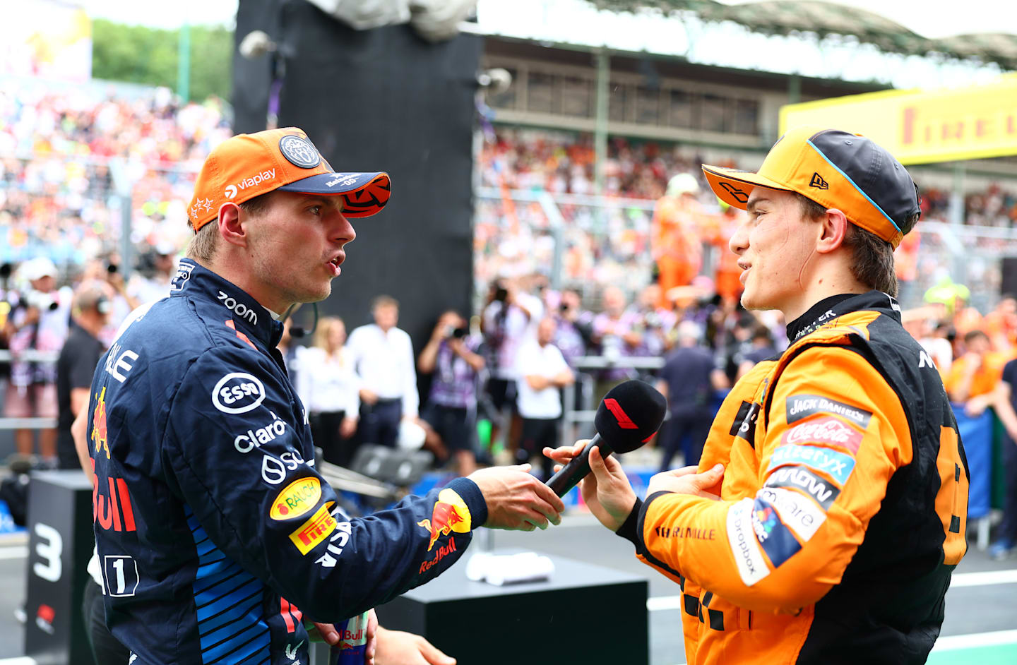 BUDAPEST, HUNGARY - JULY 20: Third placed qualifier Max Verstappen of the Netherlands and Oracle Red Bull Racing and Second placed qualifier Oscar Piastri of Australia and McLaren talk in parc ferme during qualifying ahead of the F1 Grand Prix of Hungary at Hungaroring on July 20, 2024 in Budapest, Hungary. (Photo by Bryn Lennon - Formula 1/Formula 1 via Getty Images)