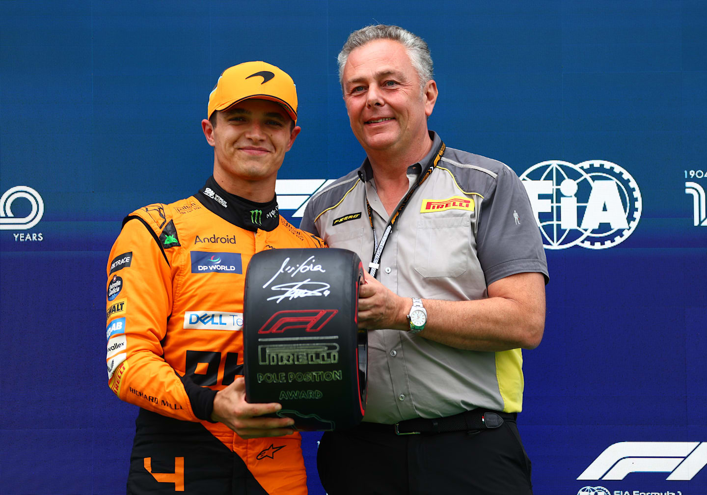 BUDAPEST, HUNGARY - JULY 20: Pole position qualifier Lando Norris of Great Britain and McLaren is presented with the Pirelli Pole Position trophy by Director of Pirelli F1 Mario Isola in parc ferme during qualifying ahead of the F1 Grand Prix of Hungary at Hungaroring on July 20, 2024 in Budapest, Hungary. (Photo by Bryn Lennon - Formula 1/Formula 1 via Getty Images)