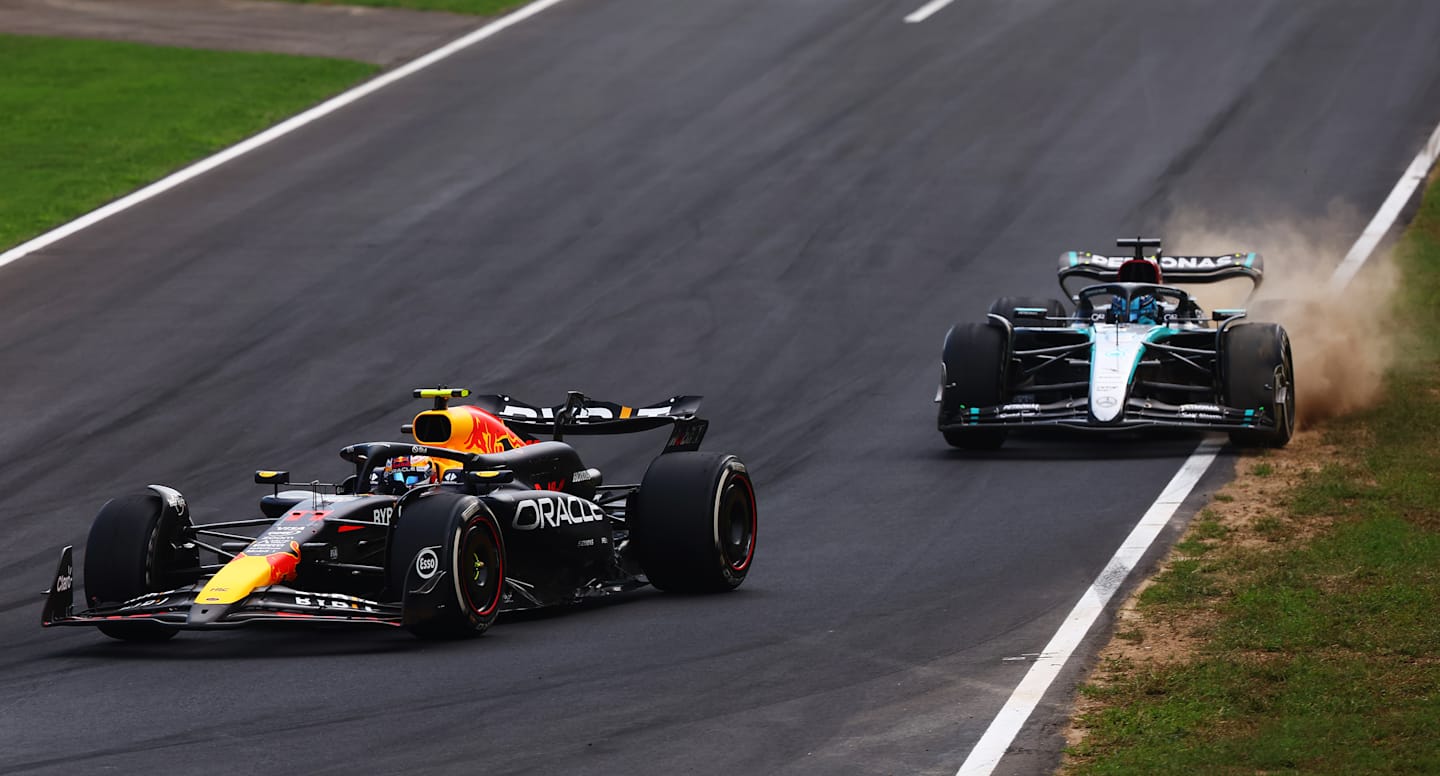 MONZA, ITALY - SEPTEMBER 01: Sergio Perez of Mexico driving the (11) Oracle Red Bull Racing RB20 leads George Russell of Great Britain driving the (63) Mercedes AMG Petronas F1 Team W15 on track during the F1 Grand Prix of Italy at Autodromo Nazionale Monza on September 01, 2024 in Monza, Italy. (Photo by Joe Portlock - Formula 1/Formula 1 via Getty Images)