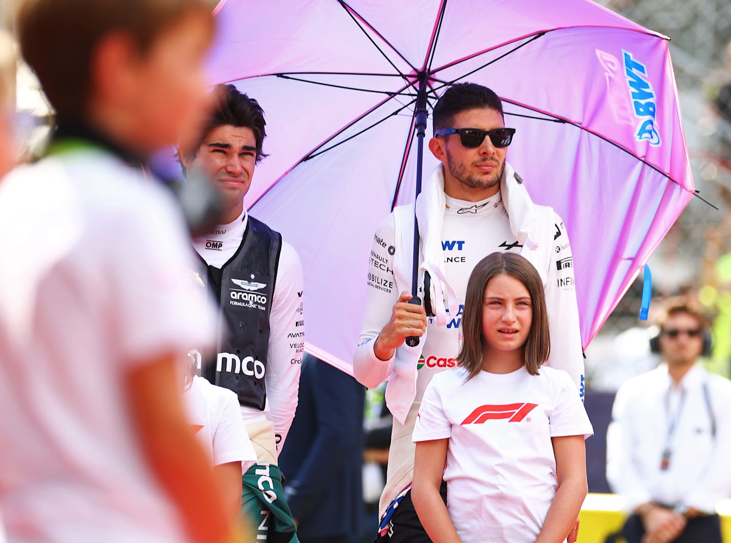 MONZA, ITALY - SEPTEMBER 01: Lance Stroll of Canada and Aston Martin F1 Team and Esteban Ocon of France and Alpine F1 looks on, on the grid during the F1 Grand Prix of Italy at Autodromo Nazionale Monza on September 01, 2024 in Monza, Italy. (Photo by Bryn Lennon - Formula 1/Formula 1 via Getty Images)