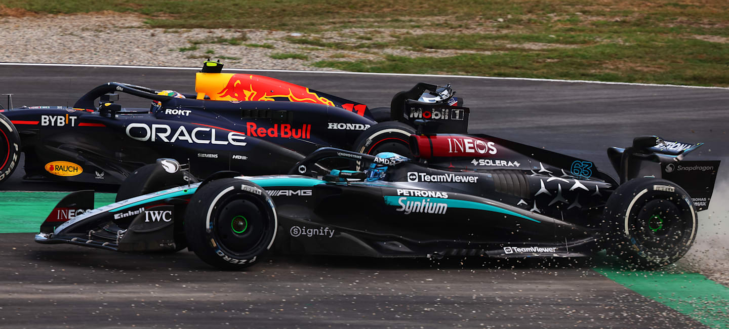 MONZA, ITALY - SEPTEMBER 01: George Russell of Great Britain driving the (63) Mercedes AMG Petronas F1 Team W15 runs wide during a battle with Sergio Perez of Mexico driving the (11) Oracle Red Bull Racing RB20 during the F1 Grand Prix of Italy at Autodromo Nazionale Monza on September 01, 2024 in Monza, Italy. (Photo by Joe Portlock - Formula 1/Formula 1 via Getty Images)