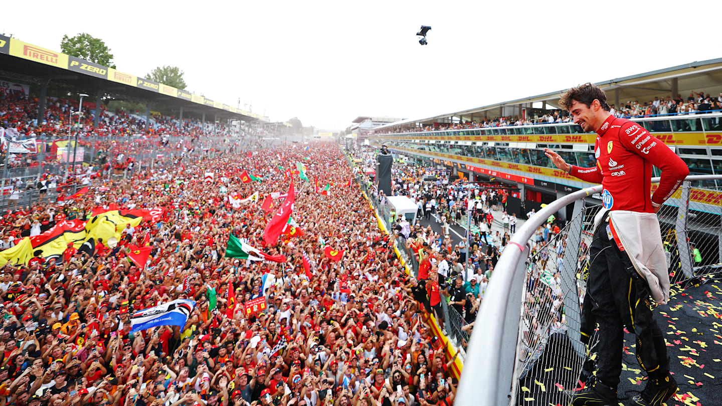 MONZA, ITALY - SEPTEMBER 01: Race winner Charles Leclerc of Monaco and Ferrari waves to fans from the podium during the F1 Grand Prix of Italy at Autodromo Nazionale Monza on September 01, 2024 in Monza, Italy. (Photo by Bryn Lennon - Formula 1/Formula 1 via Getty Images)