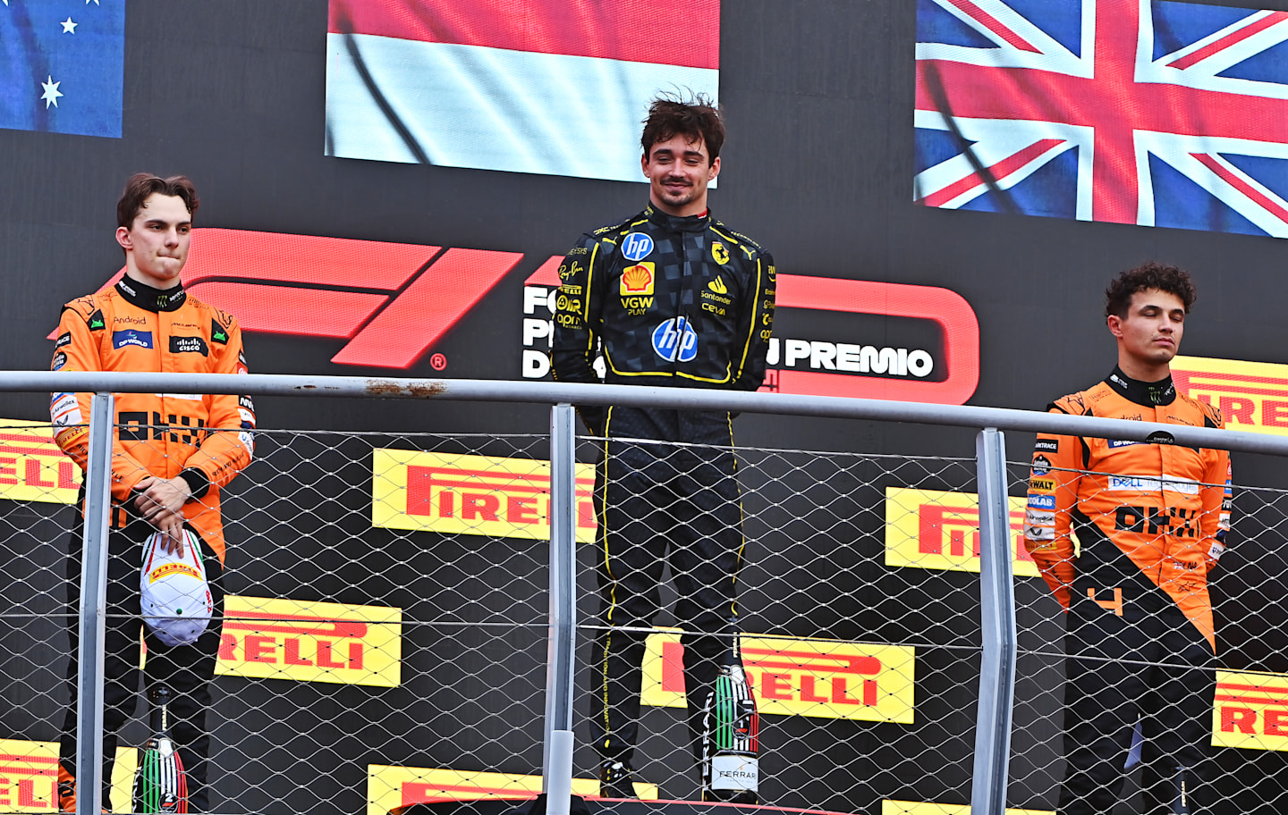 MONZA, ITALY - SEPTEMBER 01: Race winner Charles Leclerc of Monaco and Ferrari, with Second placed Oscar Piastri of Australia and McLaren and Third placed Lando Norris of GB and McLaren. (Photo by James Sutton - Formula 1/Formula 1 via Getty Images)