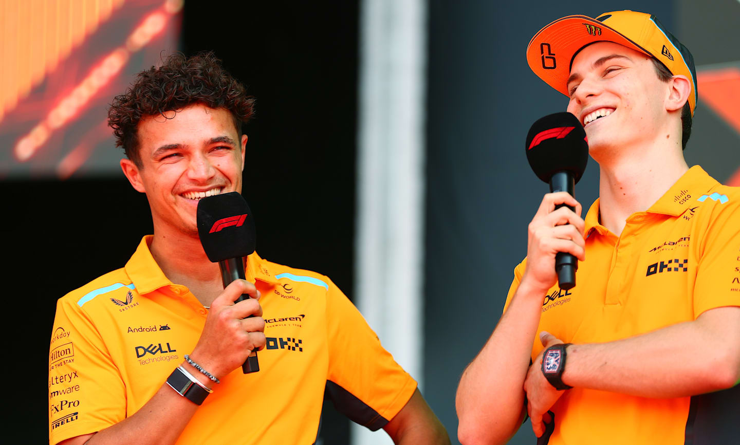 MONZA, ITALY - AUGUST 30: Lando Norris of Great Britain and McLaren and Oscar Piastri of Australia and McLaren, on the fan forum stage prior to practice ahead of the F1 Grand Prix of Italy. (Photo by Peter Fox - Formula 1/Formula 1 via Getty Images)