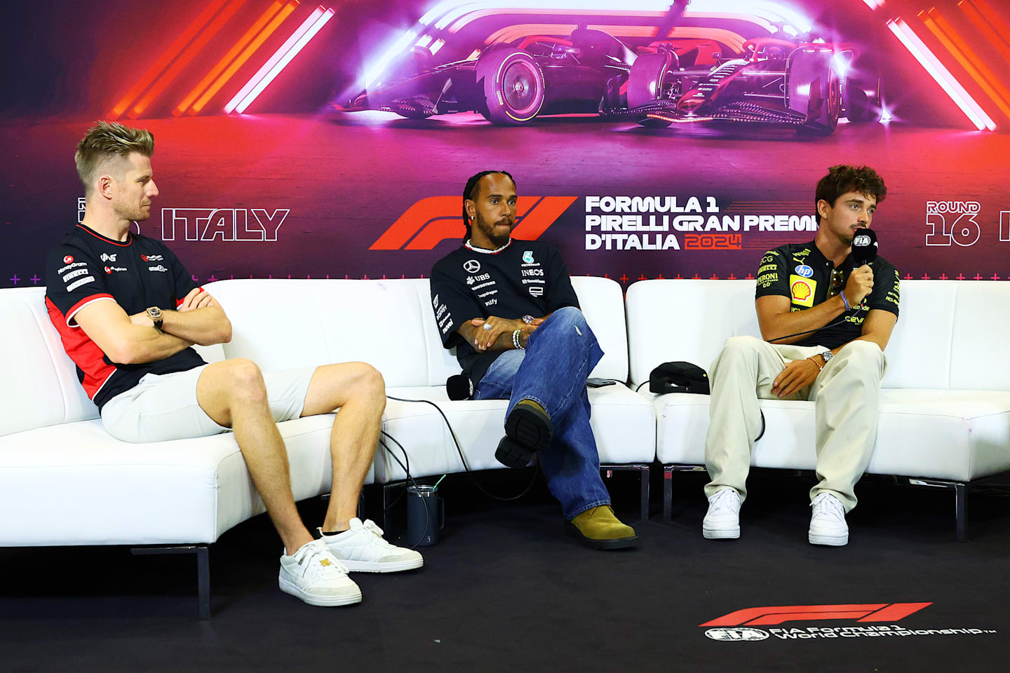 MONZA, ITALY - AUGUST 29: (L-R) Nico Hulkenberg of Germany and Haas F1, Lewis Hamilton of Great Britain and Mercedes and Charles Leclerc of Monaco and Ferrari attend the Drivers Press Conference during previews ahead of the F1 Grand Prix of Italy at Autodromo Nazionale Monza on August 29, 2024 in Monza, Italy. (Photo by Clive Rose/Getty Images)