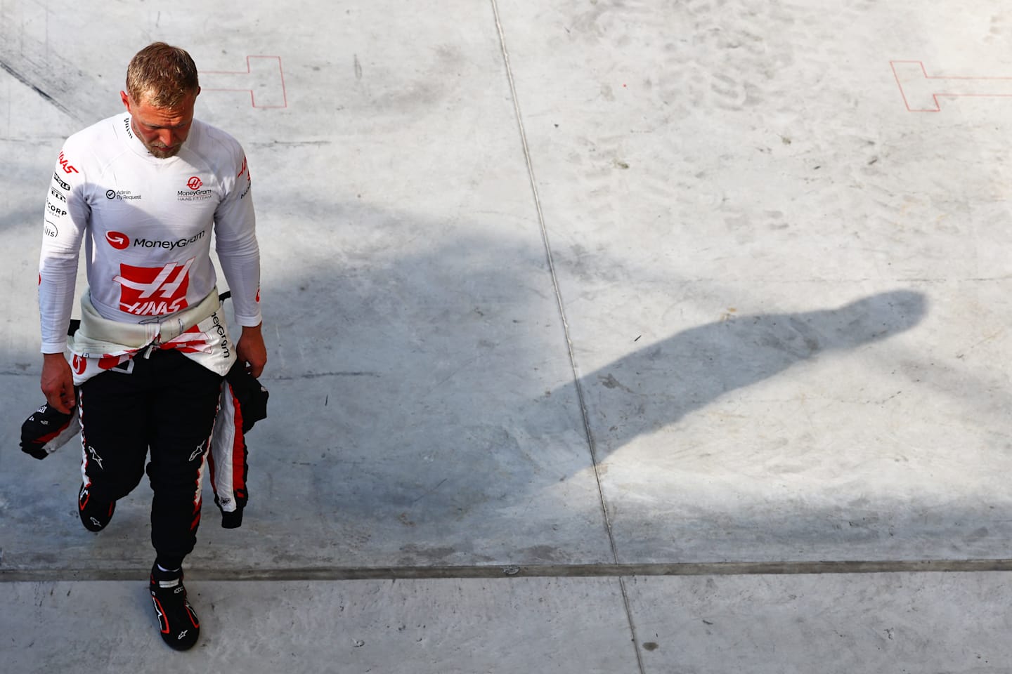 MONZA, ITALY - AUGUST 31: Thirteenth qualifier Kevin Magnussen of Denmark and Haas F1 walks in the Pitlane during qualifying ahead of the F1 Grand Prix of Italy at Autodromo Nazionale Monza on August 31, 2024 in Monza, Italy. (Photo by Mark Thompson/Getty Images)