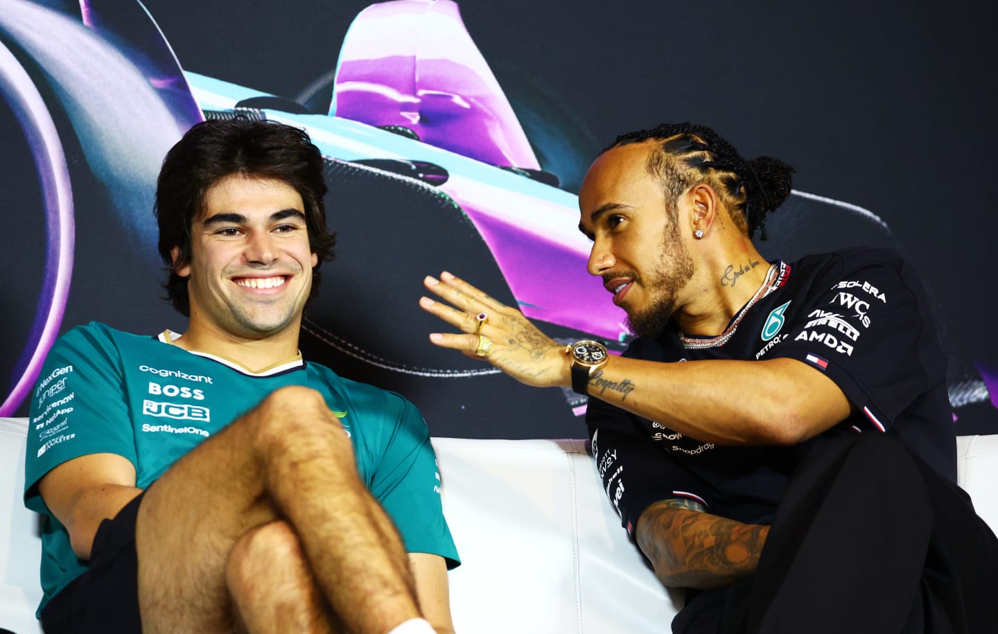 MIAMI, FLORIDA - MAY 02: Lance Stroll of Canada and Aston Martin F1 Team and Lewis Hamilton of Great Britain and Mercedes talk in the Drivers Press Conference during previews ahead of the F1 Grand Prix of Miami at Miami International Autodrome on May 02, 2024 in Miami, Florida. (Photo by Clive Rose/Getty Images)