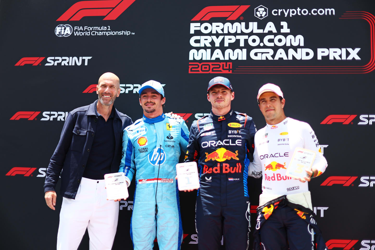 MIAMI, FLORIDA - MAY 04: Sprint winner Max Verstappen of the Netherlands and Oracle Red Bull Racing, Second placed Charles Leclerc of Monaco and Ferrari, Third placed Sergio Perez of Mexico and Oracle Red Bull Racing and Zinedine Zidane pose for a photo in parc ferme during the Sprint ahead of the F1 Grand Prix of Miami at Miami International Autodrome on May 04, 2024 in Miami, Florida. (Photo by Clive Rose - Formula 1/Formula 1 via Getty Images)