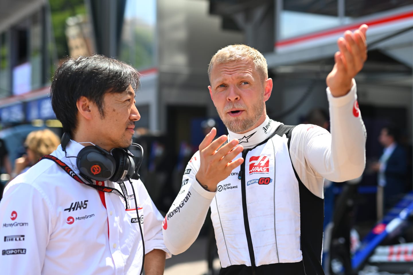 MONTE-CARLO, MONACO - MAY 26: Kevin Magnussen of Denmark and Haas F1 talks with Haas F1 Team Principal Ayao Komatsu on the grid prior to the F1 Grand Prix of Monaco at Circuit de Monaco on May 26, 2024 in Monte-Carlo, Monaco. (Photo by Rudy Carezzevoli/Getty Images)
