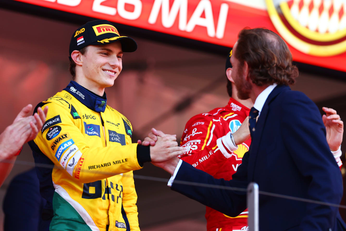 MONTE-CARLO, MONACO - MAY 26: Second placed Oscar Piastri of Australia and McLaren celebrates with Andrea Casiraghi on the podium during the F1 Grand Prix of Monaco at Circuit de Monaco on May 26, 2024 in Monte-Carlo, Monaco. (Photo by Bryn Lennon - Formula 1/Formula 1 via Getty Images)