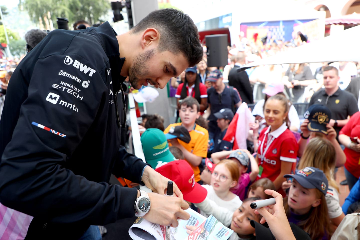 MONTE-CARLO, MONACO - MAY 24: Esteban Ocon of France and Alpine F1 signs autographs for fans in the fan stage prior to practice ahead of the F1 Grand Prix of Monaco at Circuit de Monaco on May 24, 2024 in Monte-Carlo, Monaco. (Photo by Peter Fox - Formula 1/Formula 1 via Getty Images)