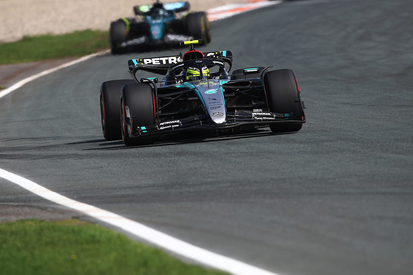 ZANDVOORT, NETHERLANDS - AUGUST 25: Lewis Hamilton of Great Britain driving the (44) Mercedes AMG Petronas F1 Team W15 leads Lance Stroll of Canada driving the (18) Aston Martin AMR24 Mercedes during the F1 Grand Prix of Netherlands at Circuit Zandvoort on August 25, 2024 in Zandvoort, Netherlands. (Photo by Joe Portlock/Getty Images)