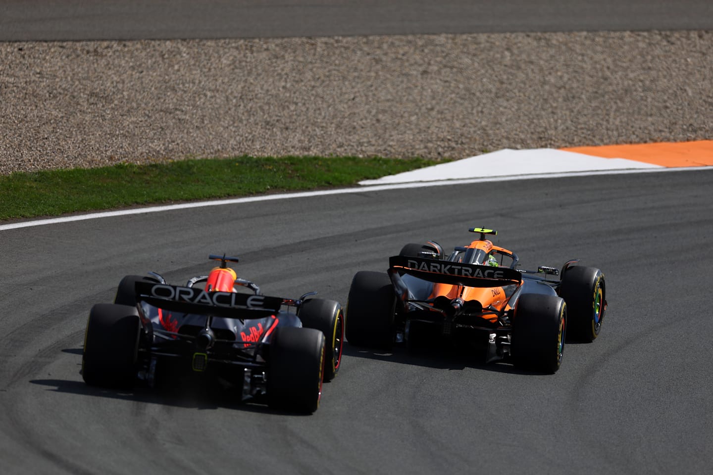 ZANDVOORT, NETHERLANDS - AUGUST 25: Lando Norris of Great Britain driving the (4) McLaren MCL38 Mercedes leads Max Verstappen of the Netherlands driving the (1) Oracle Red Bull Racing RB20 during the F1 Grand Prix of Netherlands at Circuit Zandvoort on August 25, 2024 in Zandvoort, Netherlands. (Photo by Bryn Lennon - Formula 1/Formula 1 via Getty Images)