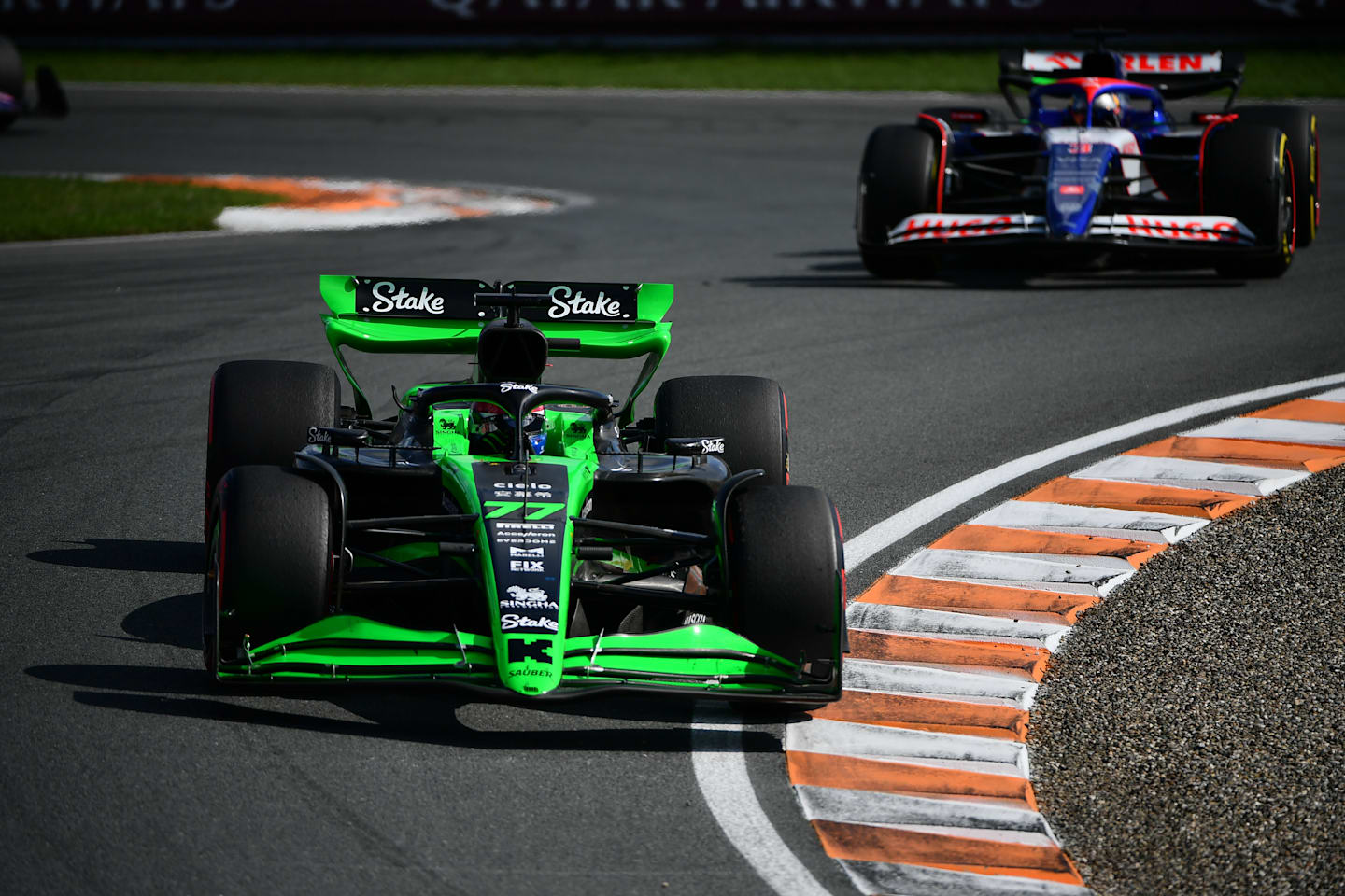 ZANDVOORT, NETHERLANDS - AUGUST 25: Valtteri Bottas of Finland driving the (77) Kick Sauber C44 Ferrari leads Daniel Ricciardo of Australia driving the (3) Visa Cash App RB VCARB 01 during the F1 Grand Prix of Netherlands at Circuit Zandvoort on August 25, 2024 in Zandvoort, Netherlands. (Photo by James Sutton - Formula 1/Formula 1 via Getty Images)