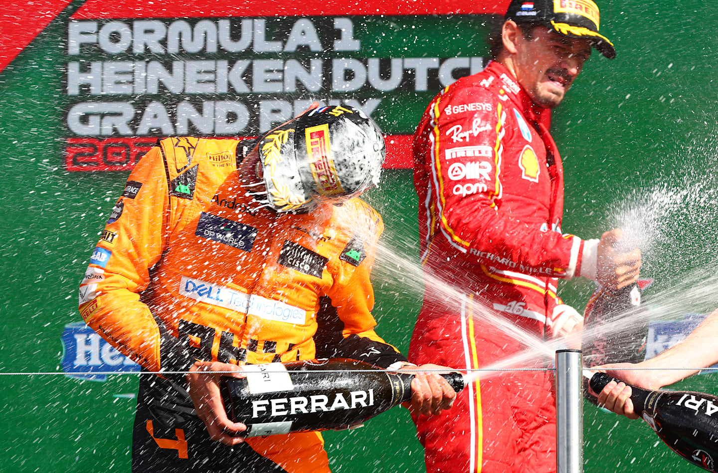 ZANDVOORT, NETHERLANDS - AUGUST 25: Race winner Lando Norris of Great Britain and McLaren and third placed Charles Leclerc of Monaco and Ferrari celebrate in parc ferme after the F1 Grand Prix of Netherlands at Circuit Zandvoort on August 25, 2024 in Zandvoort, Netherlands. (Photo by Joe Portlock/Getty Images)