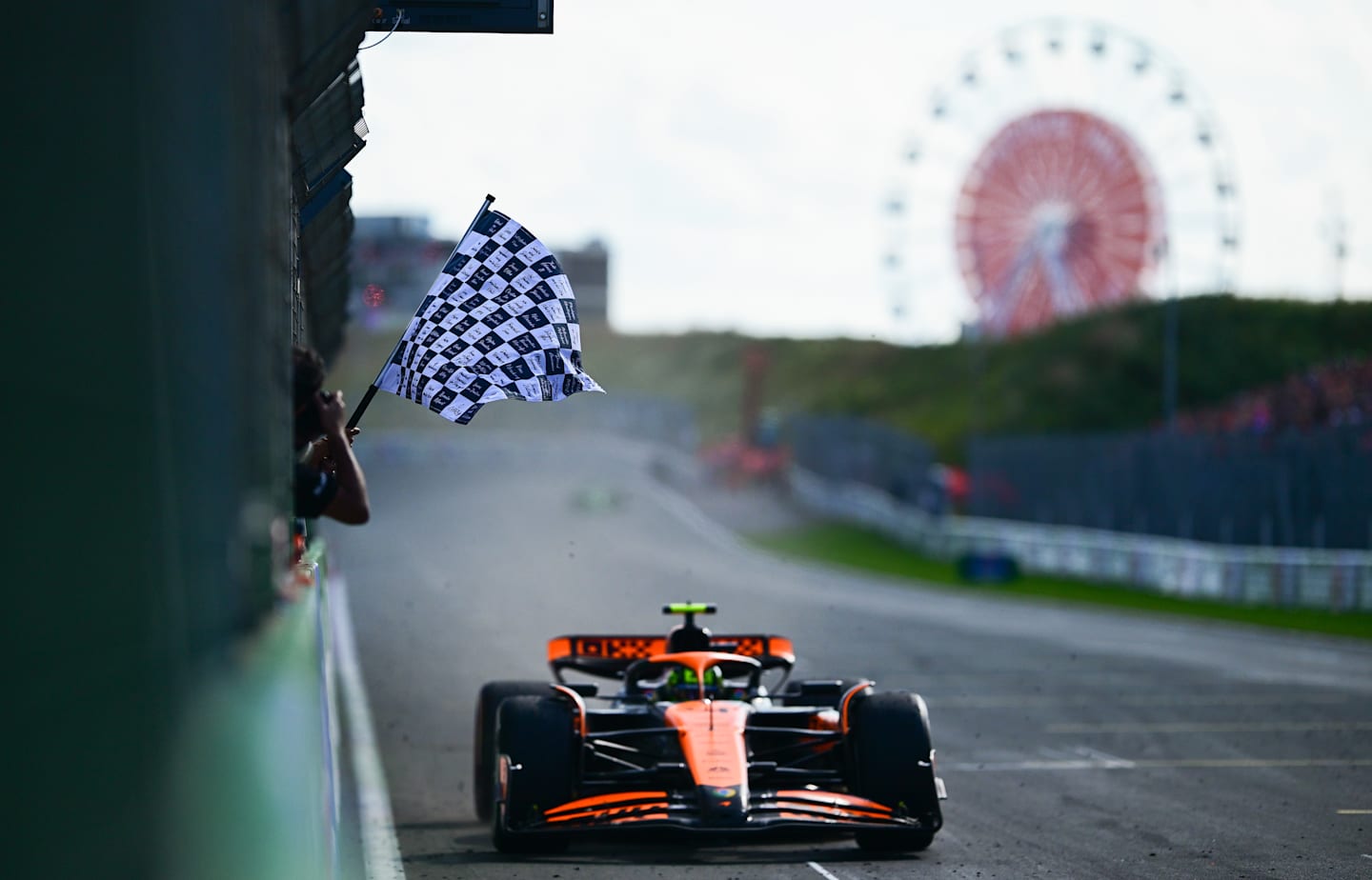 ZANDVOORT, NETHERLANDS - AUGUST 25: Lando Norris of Great Britain driving the (4) McLaren MCL38 Mercedes takes the chequered flag during the F1 Grand Prix of Netherlands. (Photo by Mario Renzi - Formula 1/Formula 1 via Getty Images)