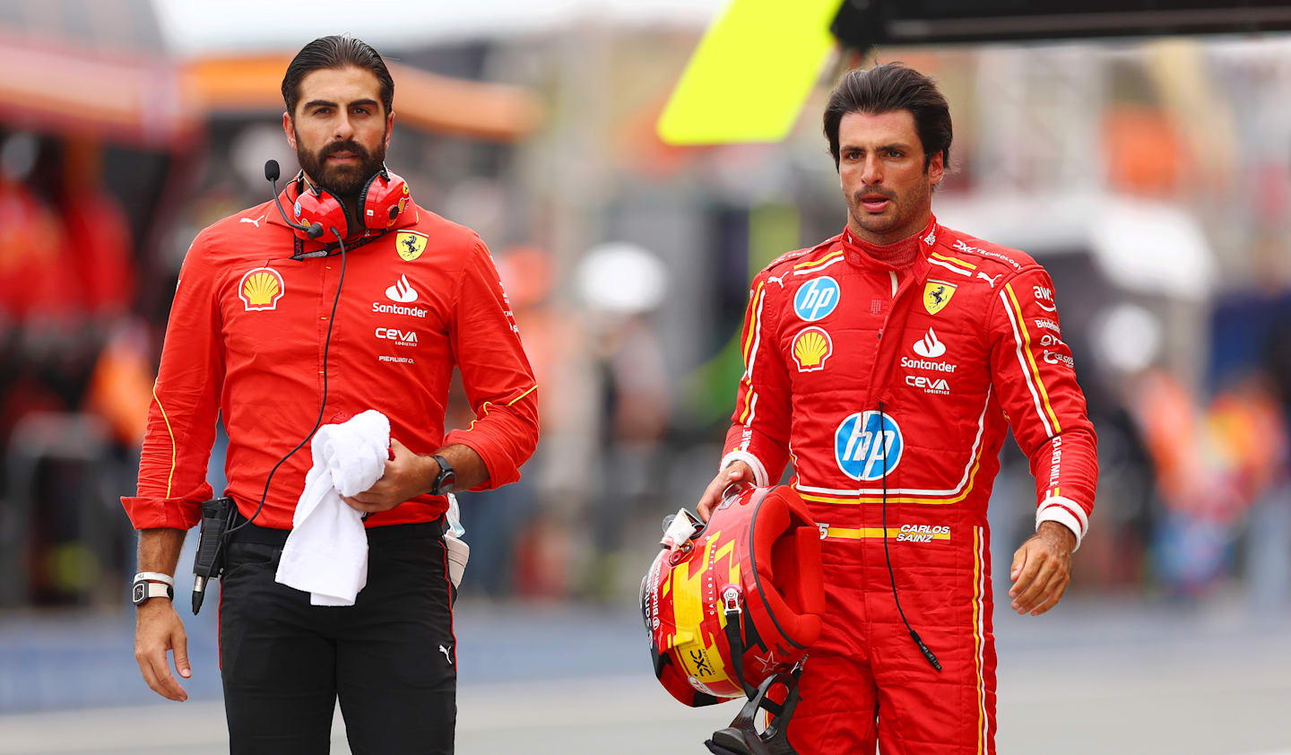 ZANDVOORT, NETHERLANDS - AUGUST 24: 11th placed qualifier Carlos Sainz of Spain and Ferrari walks in the Pitlane during qualifying ahead of the F1 Grand Prix of Netherlands at Circuit Zandvoort on August 24, 2024 in Zandvoort, Netherlands. (Photo by Bryn Lennon - Formula 1/Formula 1 via Getty Images)