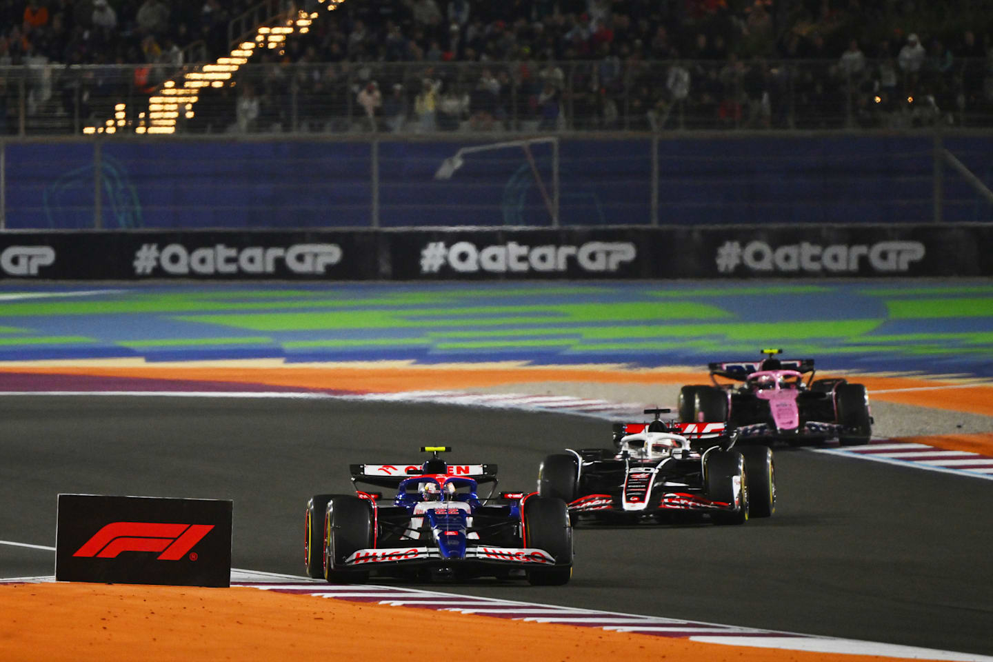 Yuki Tsunoda leads Kevin Magnussen and Pierre Gasly on track during the F1 Grand Prix of Qatar at Lusail International Circuit on December 01, 2024 in Lusail City, Qatar. (Photo by Mark Sutton - Formula 1/Formula 1 via Getty Images)