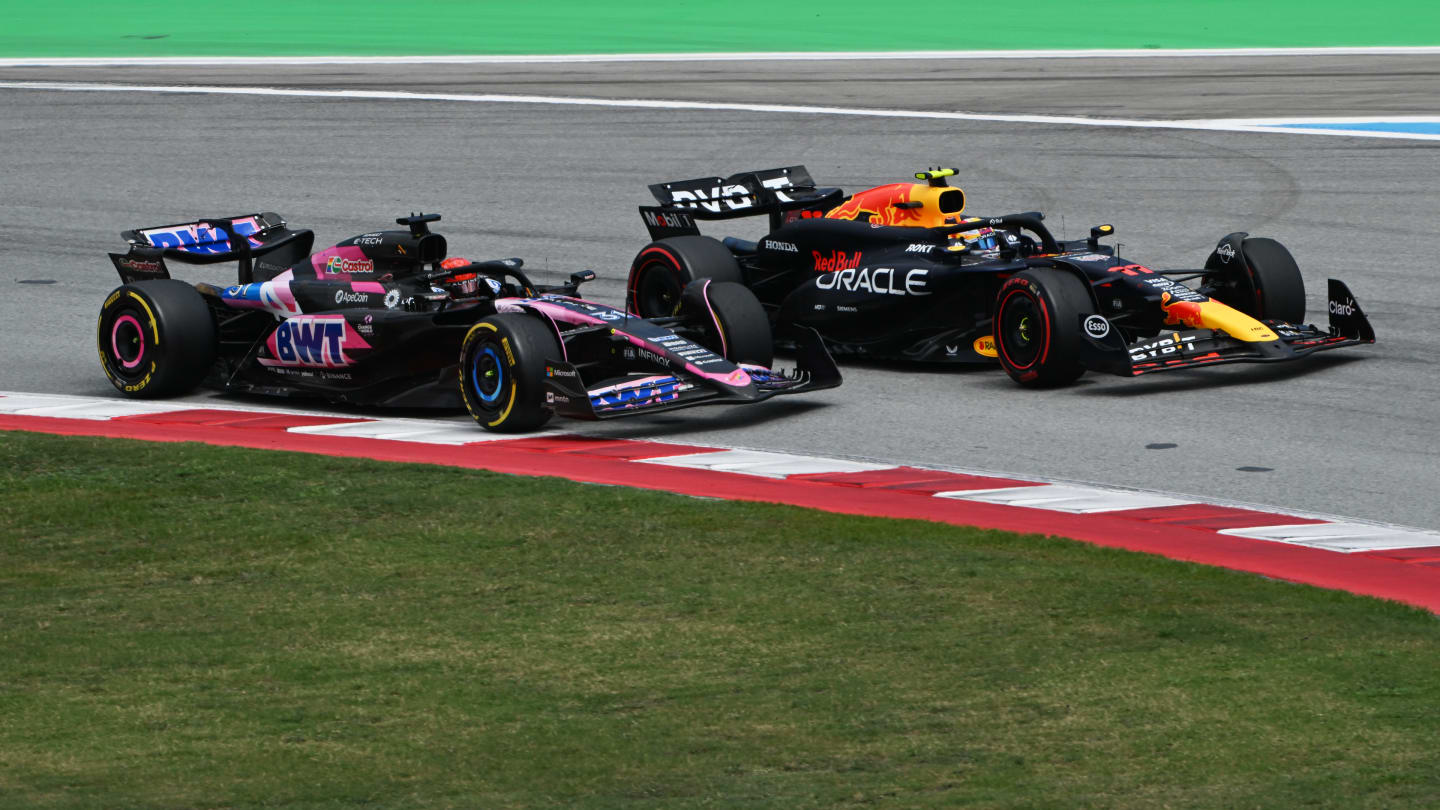 BARCELONA, SPAIN - JUNE 23: Sergio Perez of Mexico driving the (11) Oracle Red Bull Racing RB20 leads Esteban Ocon of France driving the (31) Alpine F1 A524 Renault  during the F1 Grand Prix of Spain at Circuit de Barcelona-Catalunya on June 23, 2024 in Barcelona, Spain. (Photo by Mark Sutton - Formula 1/Formula 1 via Getty Images)