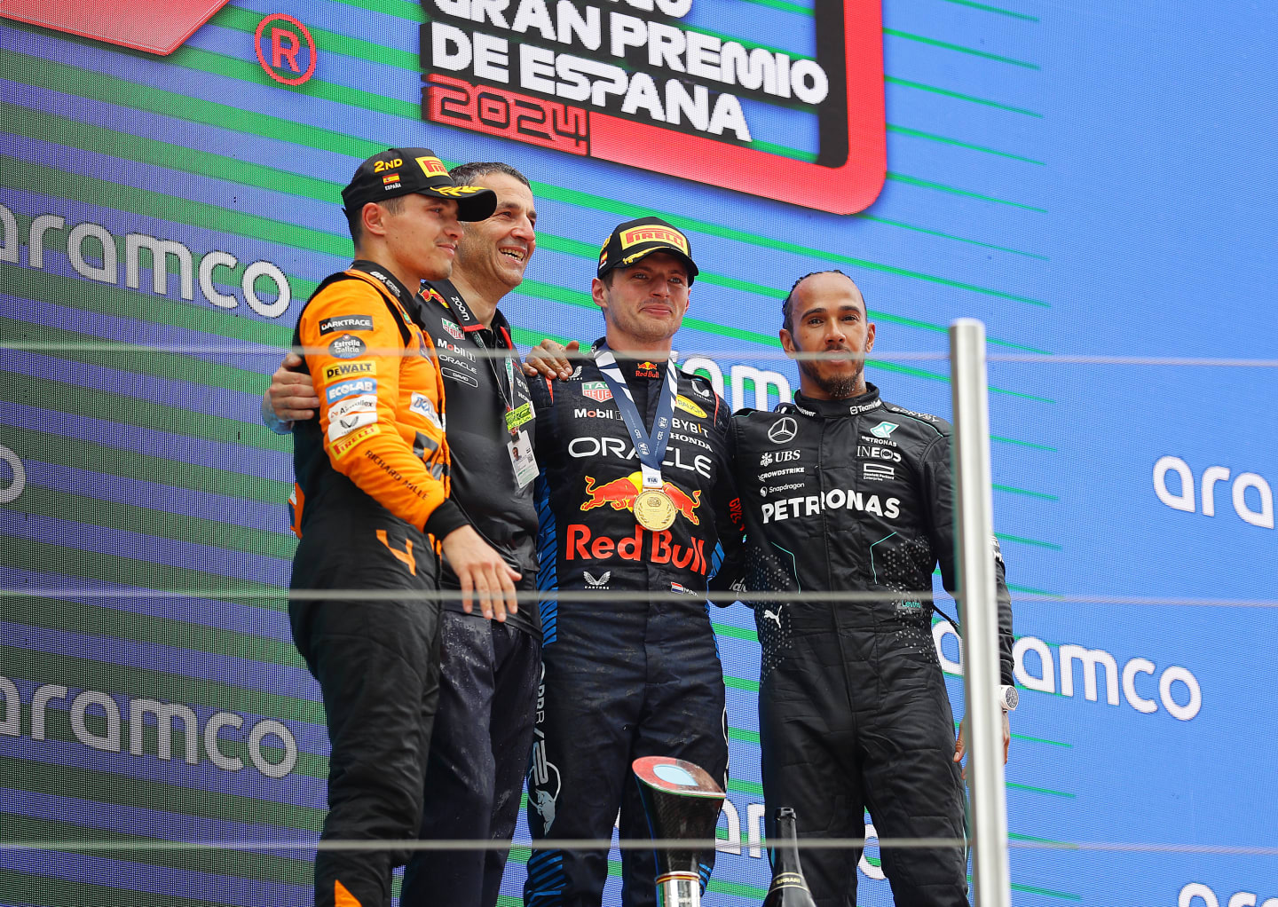 BARCELONA, SPAIN - JUNE 23: Race winner Max Verstappen of the Netherlands and Oracle Red Bull Racing, Second placed Lando Norris of Great Britain and McLaren and Third placed Lewis Hamilton of Great Britain and Mercedes celebrate on the podium during the F1 Grand Prix of Spain at Circuit de Barcelona-Catalunya on June 23, 2024 in Barcelona, Spain. (Photo by Joe Portlock - Formula 1/Formula 1 via Getty Images)