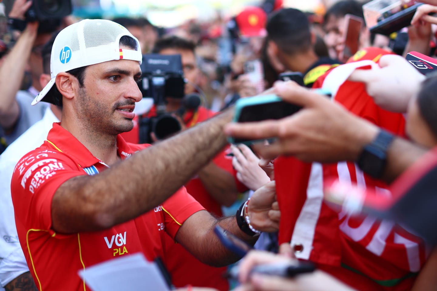 BARCELONA, SPAIN - JUNE 20: Carlos Sainz of Spain and Ferrari signs autographs for fans during