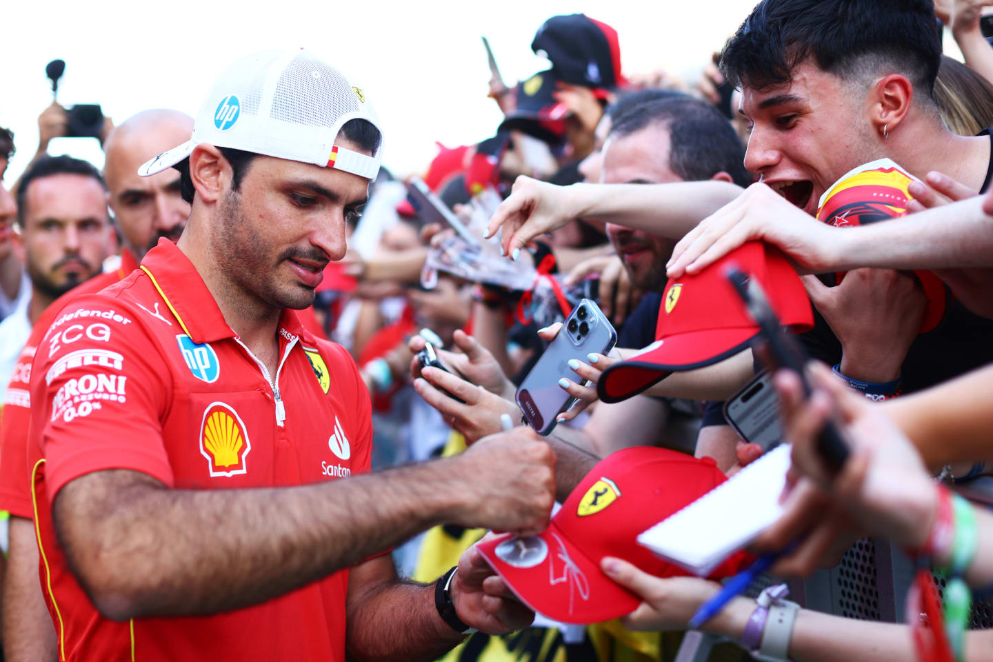 BARCELONA, SPAIN - JUNE 20: Carlos Sainz of Spain and Ferrari signs autographs for fans during