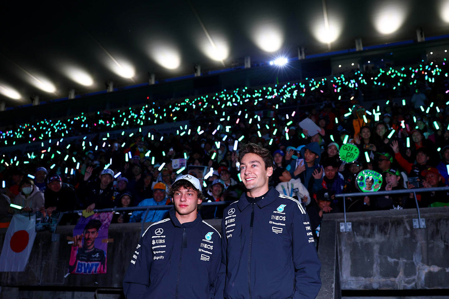 Andrea Kimi Antonelli and George Russell enjoy the fan atmosphere during qualifying ahead of the F1 Grand Prix of Japan at Suzuka Circuit on April 05, 2025 in Suzuka, Japan. (Photo by Bryn Lennon - Formula 1/Formula 1 via Getty Images)