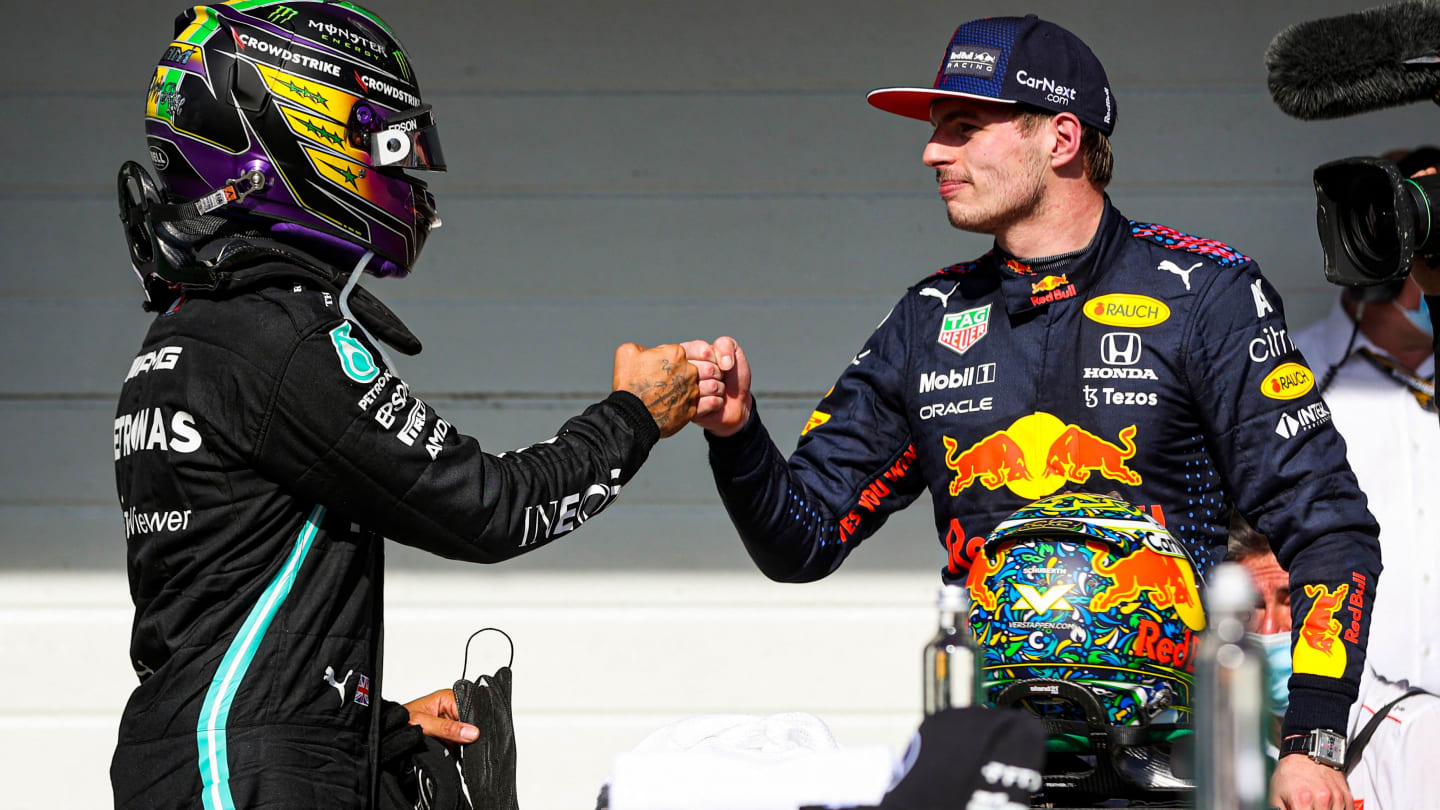 Mercedes' British driver Lewis Hamilton (L) and Red Bull's Dutch driver Max Verstappen (R) greet