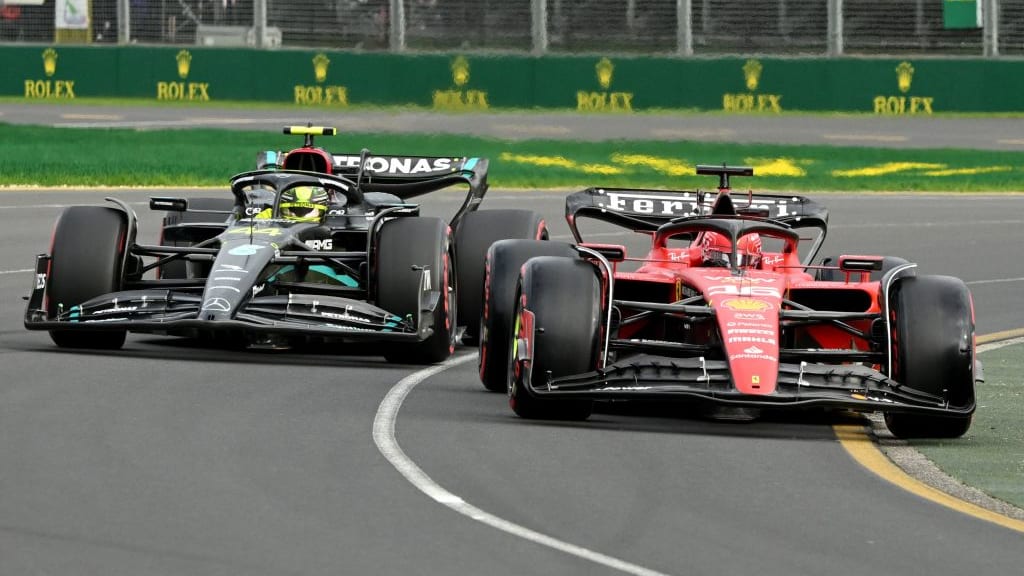 Ferrari's Monegasque driver Charles Leclerc (R) and Mercedes' British driver Lewis Hamilton drive