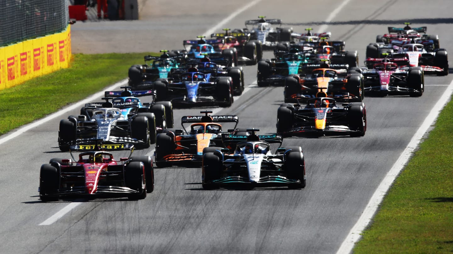 MONZA, ITALY - SEPTEMBER 11: Charles Leclerc of Monaco driving the (16) Ferrari F1-75 leads George