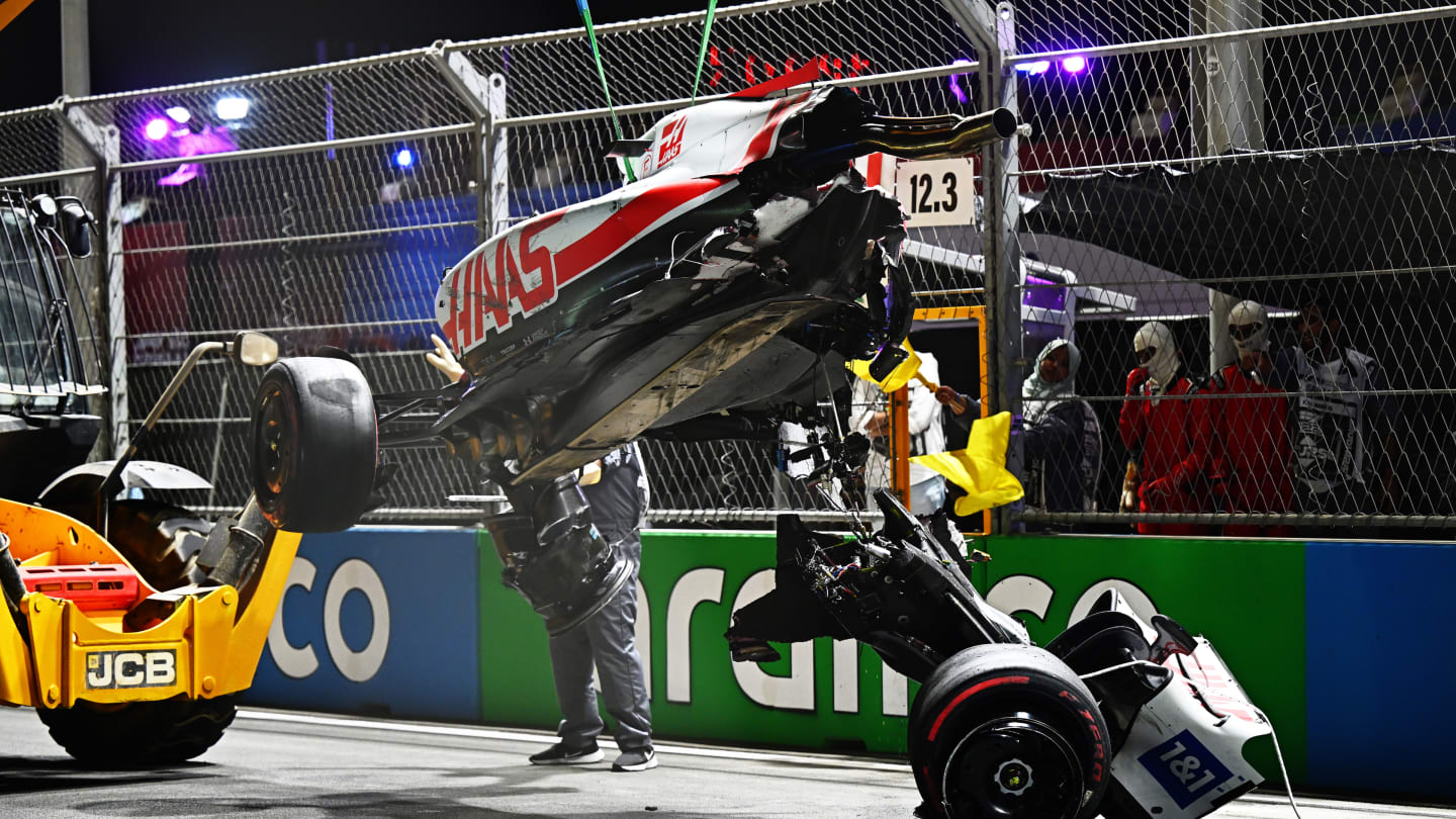 JEDDAH, SAUDI ARABIA - MARCH 26: Track marshals clean debris from the track following the crash of