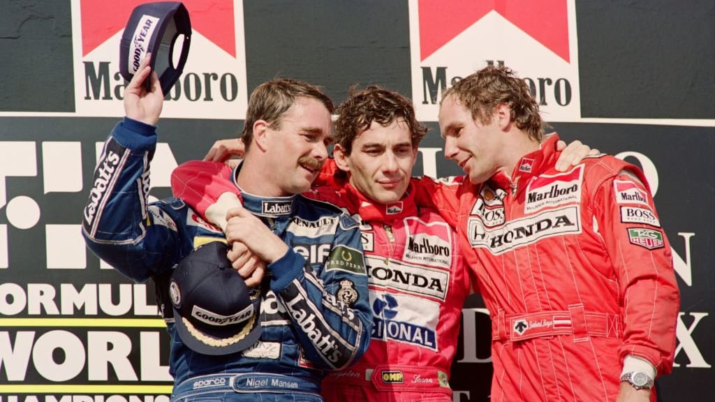 Brazilian Ayrton Senna (C) celebrates with British Nigel Mansell (R) and Austrian Gerhard Berger