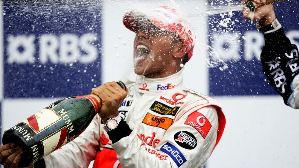 British McLaren Formula One driver Lewis Hamilton celebrates winning his first Grand Prix on the