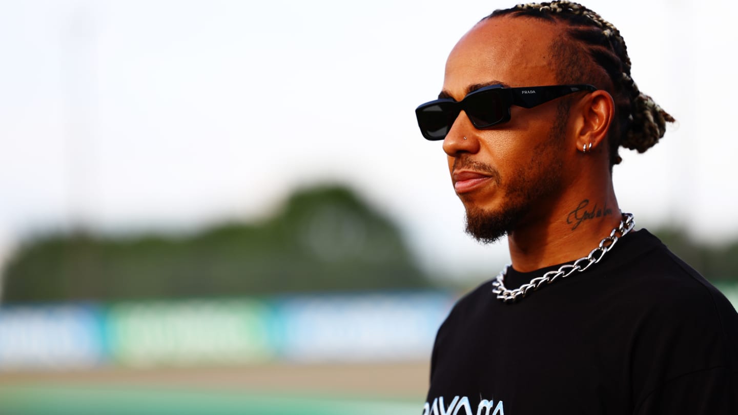 SUZUKA, JAPAN - SEPTEMBER 21: Lewis Hamilton of Great Britain and Mercedes looks on in the Paddock