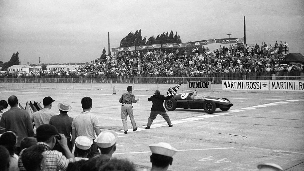 Bruce McLaren getting the checkered flag to win the first ever US Grand Prix in Sebring, Florida.