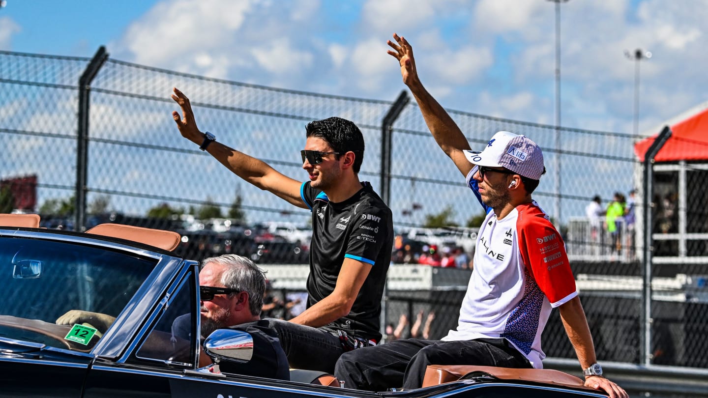 Alpine's French driver Esteban Ocon (L) and Alpine's French driver Pierre Gasly wave during the