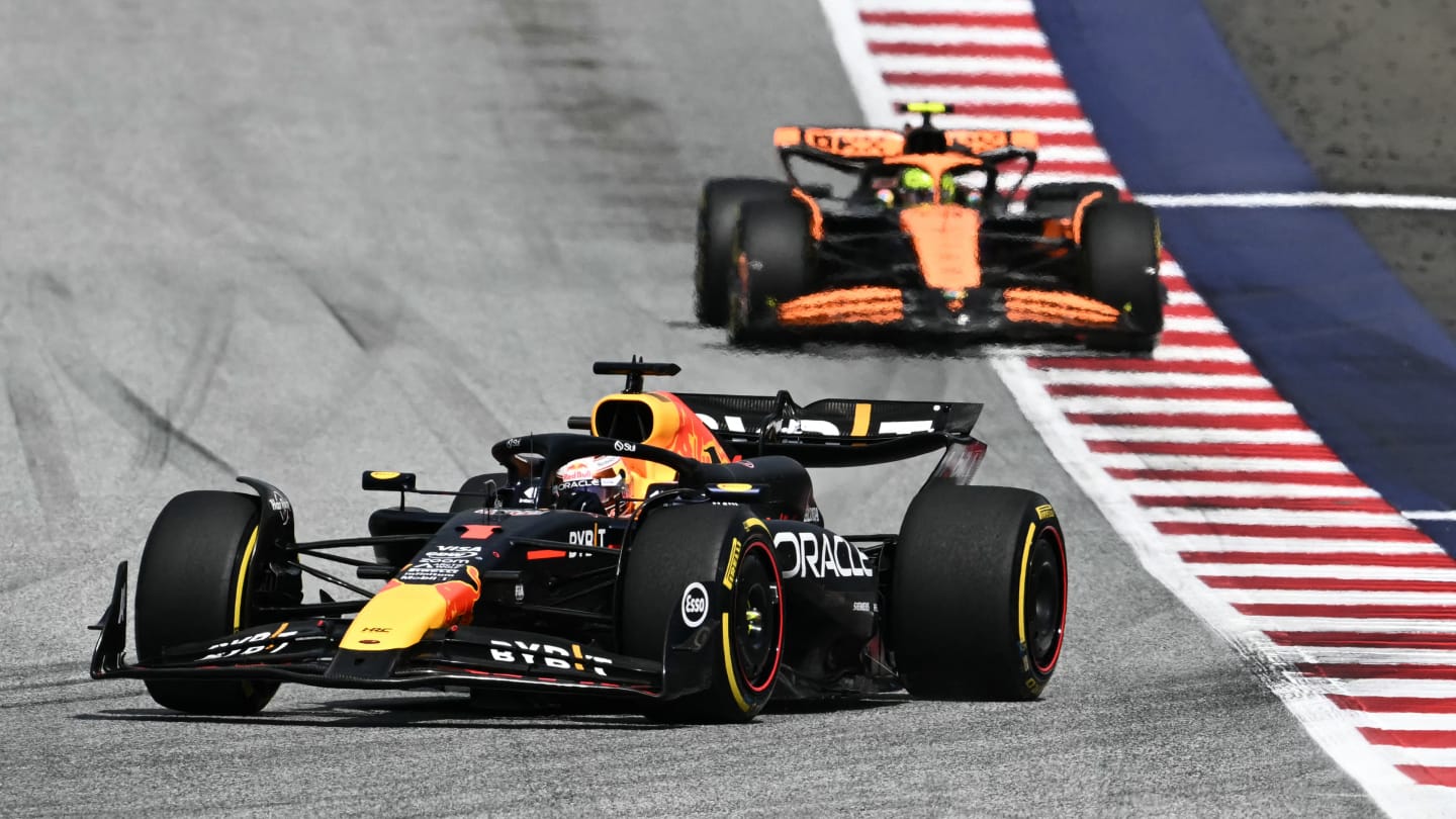 TOPSHOT - Red Bull Racing's Dutch driver Max Verstappen (front) drives ahead of McLaren's British