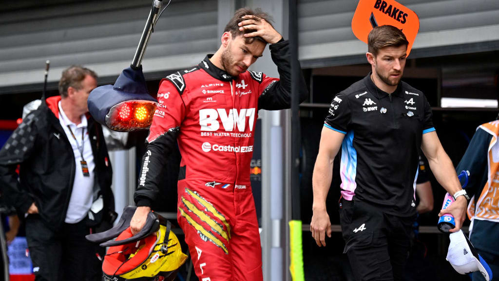 Alpine's French driver Pierre Gasly (L) leaves after the qualifying session ahead of the Formula