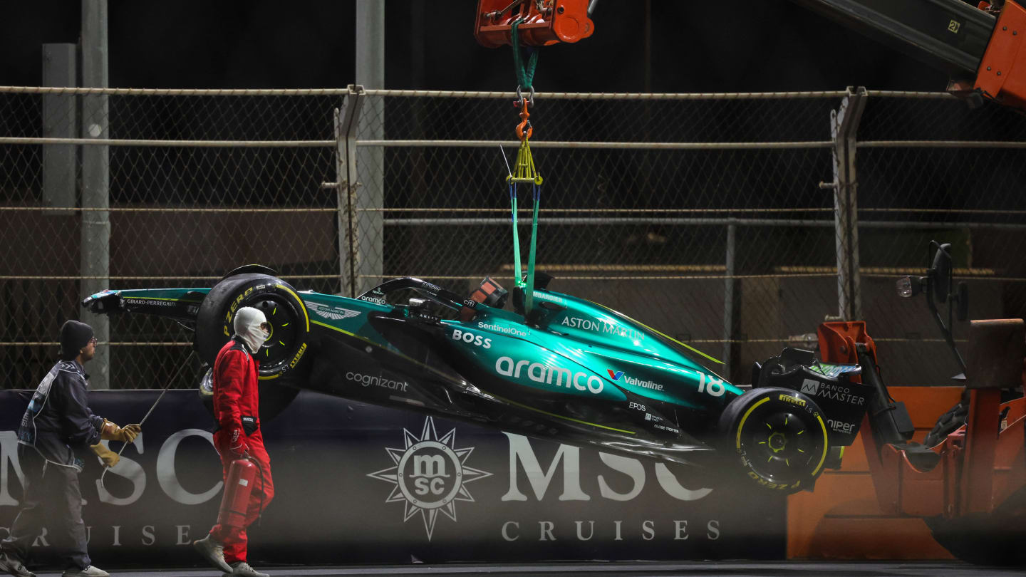 Aston Martin's Canadian driver Lance Stroll's car is hauled away after a crash during the Saudi