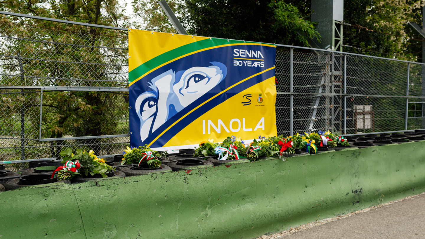 Bouquets of flowers are laid on the Tamburello wall where the Brazilian champion died during the event on May 1
